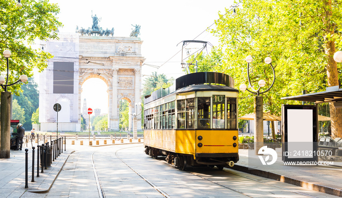 Arch of Peace view with nostalgic yellow tram in Milano, Italy.