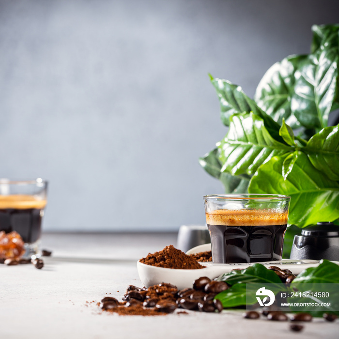 Background with glass cup of coffee, coffee beans and leafs. Beverage cafe shop concept with copy sp