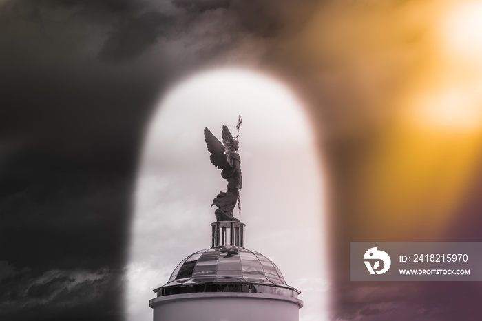 Archangel Michael sculpture against the sky in the arch.