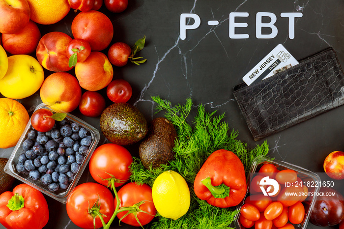 Wallet with ebt card and fresh produce on table.