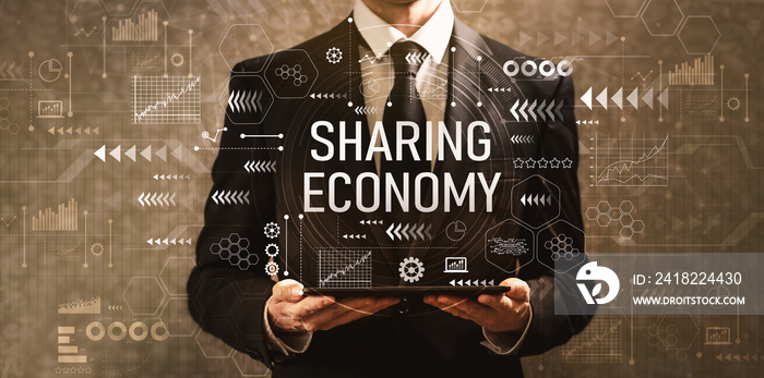 Sharing economy with businessman holding a tablet computer on a dark vintage background