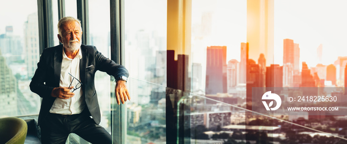 Retirement and Planning after retire concept.Senior grey-haired businessman in suit standing and loo