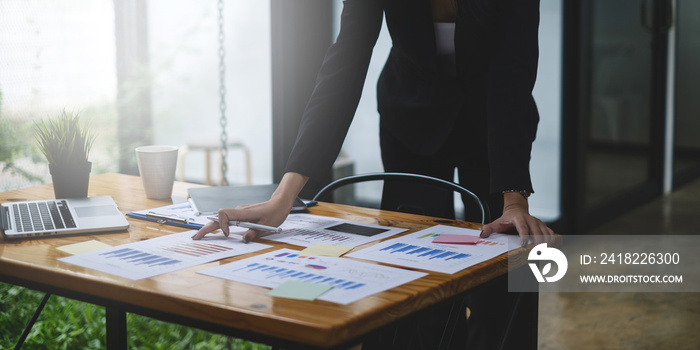 Close up Hand of Business woman working to analyze technical price graph and indicator