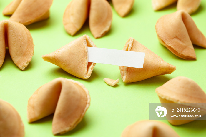 Chinese fortune cookies. Cookies with empty blank inside for prediction words. Green background.