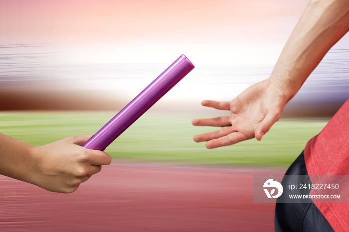 Composite image of athlete passing a baton to the partner