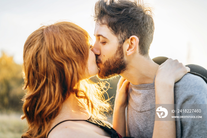 Pretty young romantic couple spend time together outdoor.