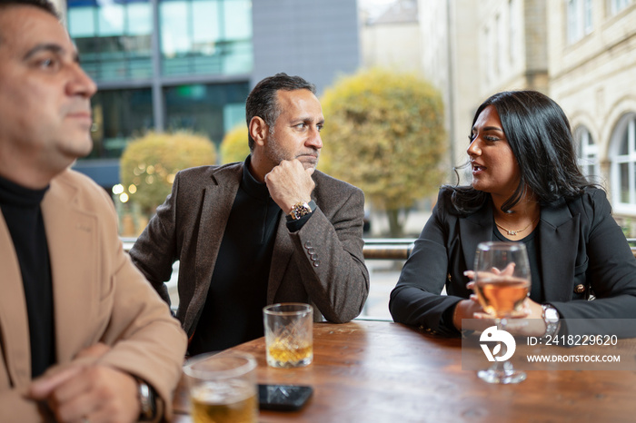 Business people having meeting in bar