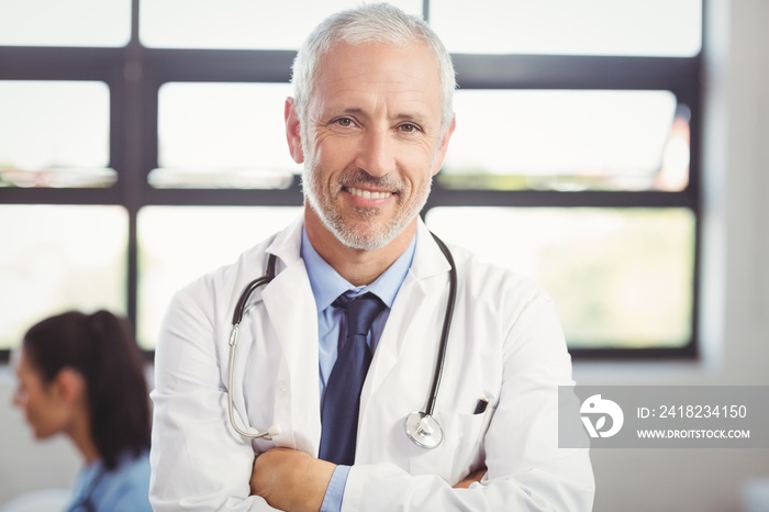 Portrait of doctor standing with arms crossed