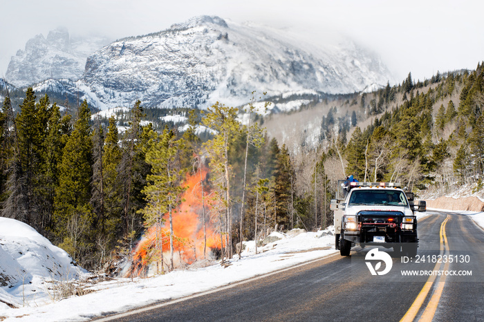 Truck driving by fire in mountains