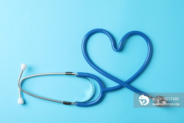 Stethoscope on blue background, space for text