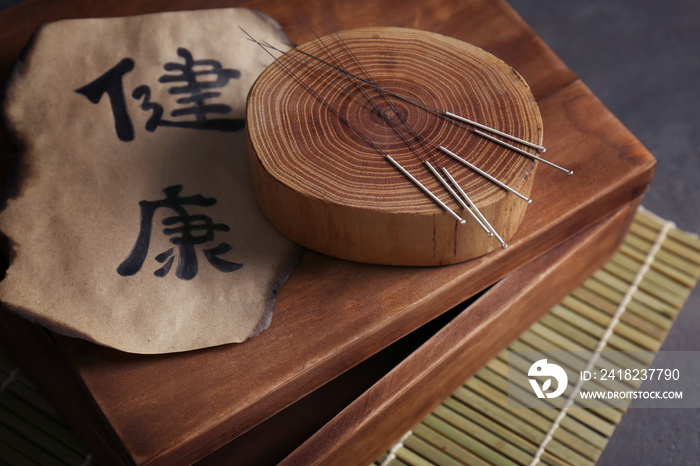 Set of needles for acupuncture on wooden stump