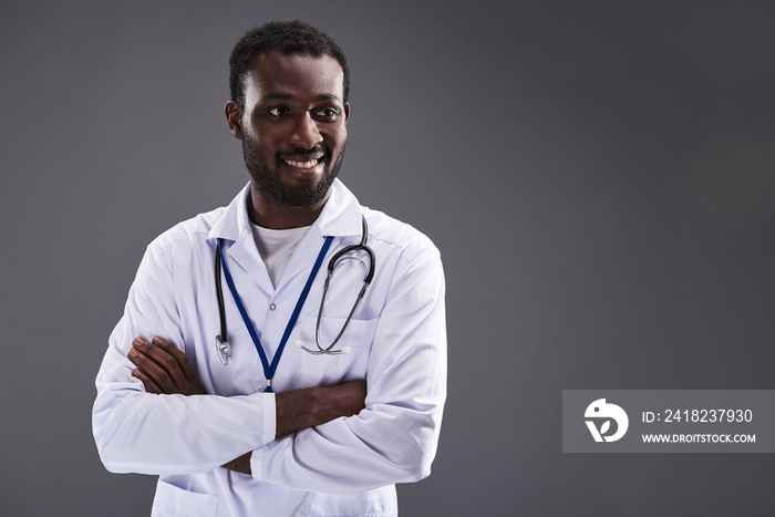 Waist up of a positive doctor folding his hands