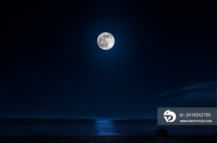 romantic and scenic panorama with full moon on sea to night, and boat on sea shore