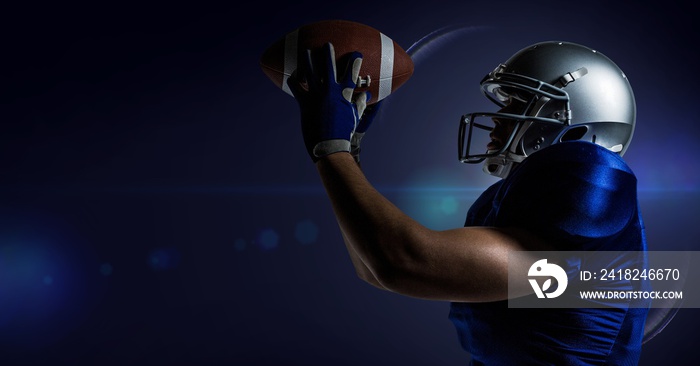 American football player catching a ball against blue background