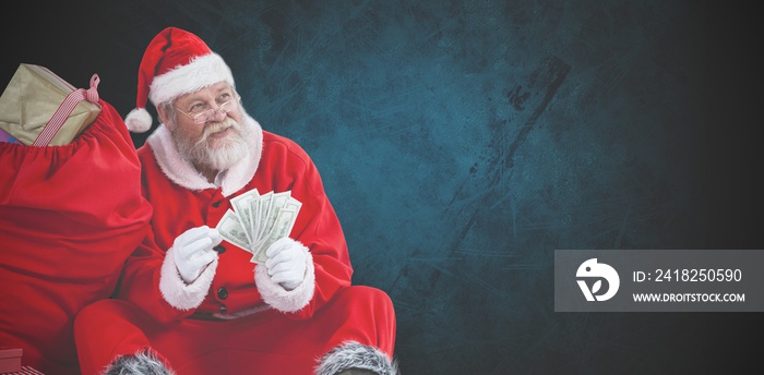 圣诞老人坐在装满礼物的袋子旁的合成图像cou