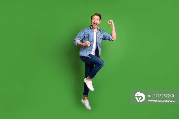 Full length body size photo of young guy jumping happy gesturing like winner cheerful isolated vivid