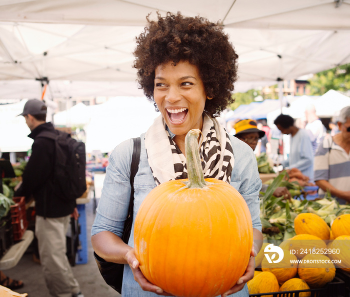 Mature woman buying pumpkin