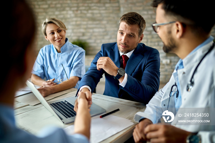 Businessman and group of doctors came to an agreement during the meeting.