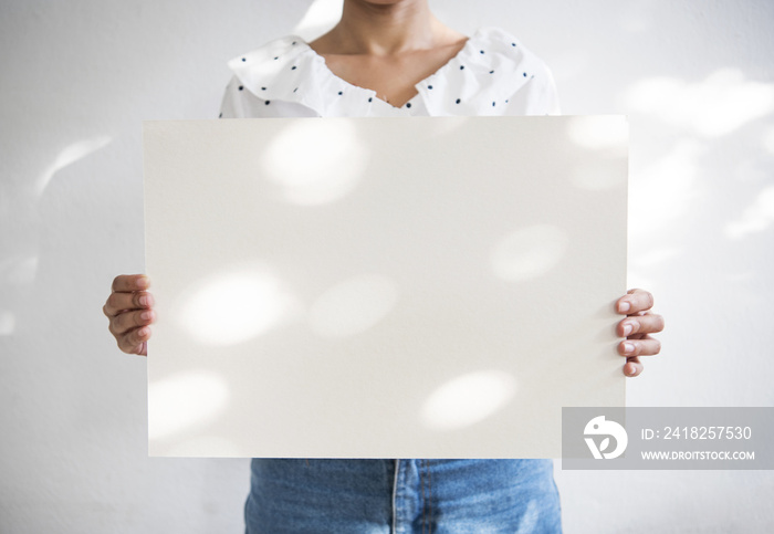 Hand Holding Blank white Photo Frame with Sunlight for Design Mockup Template.