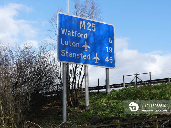 M25 motorway sign at Chorleywood, Hertfordshire showing distances to Watford, Luton Airport and Stan