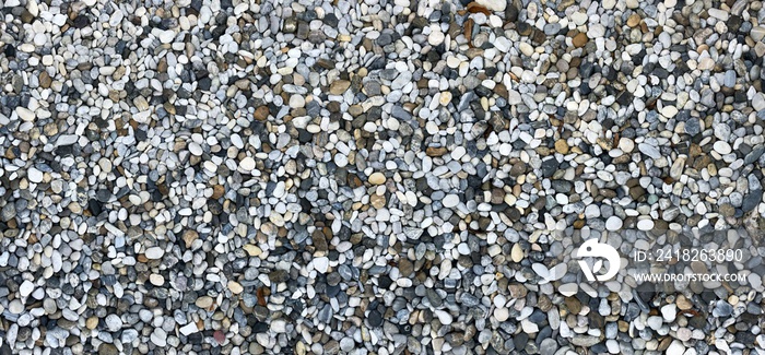 Round pebbles stones texture on garden ground for background.