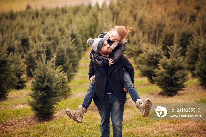 Young couple playing among trees