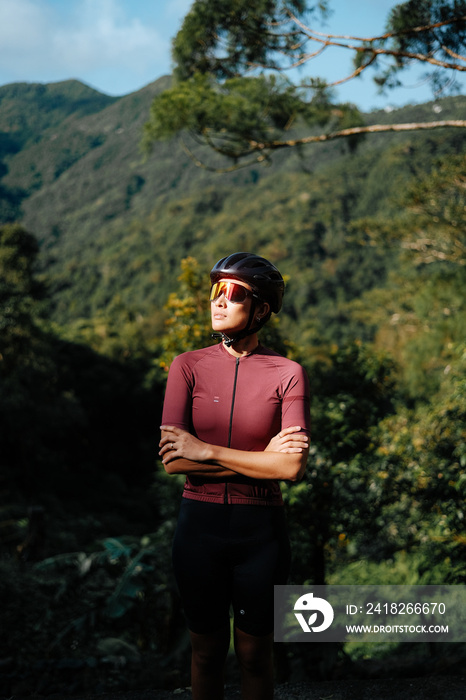 Portrait of a young female cyclist in the mountains.