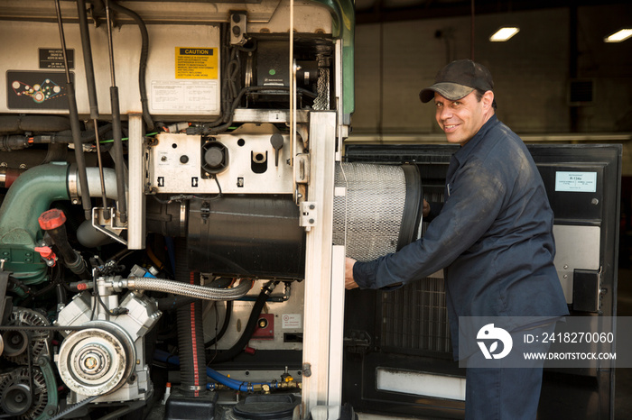 Portrait of mechanic repairing engine