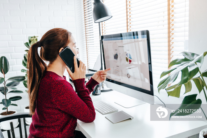 Asian woman working from home using computer and drinking coffee in her bedroom document finance and