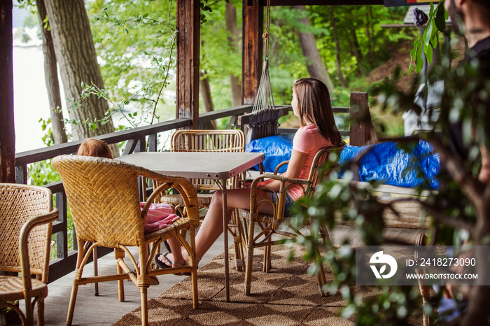 Siblings sitting on porch