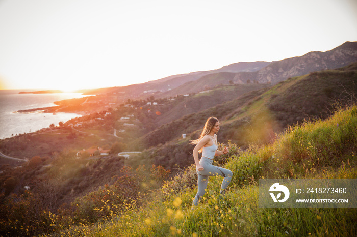 Side view of athlete on mountain during sunset