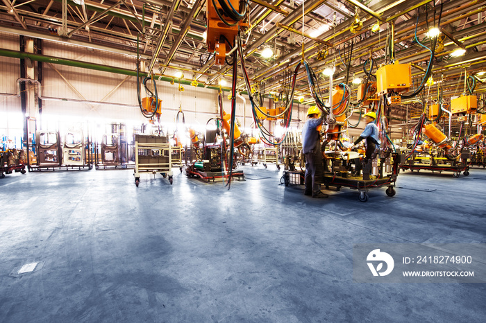 Car production line, skilled workers are working tense.