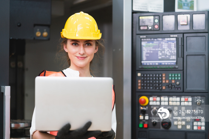 Female Engineer wear face mask ,safety vest and yellow helmet with laptop operating control CNC Mach