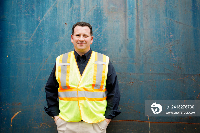 Industrial worker in front of wall