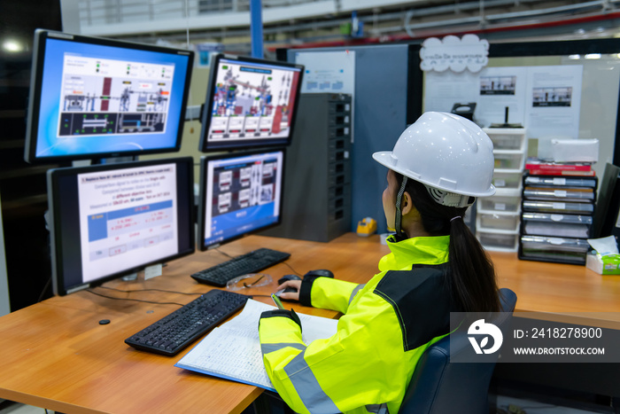 Inside the large Industry Factory Female Computer Engineer Works on Personal Computer She coding pro