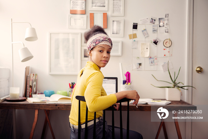 Portrait of young woman sitting at home