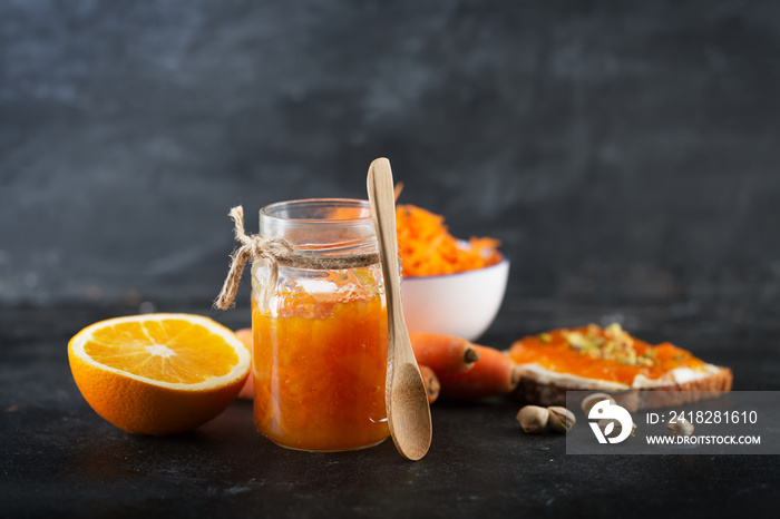 Carrot Jam with orange juice on a black background