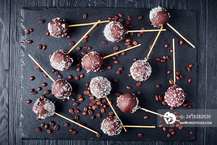 chocolate cake pops on a black tray