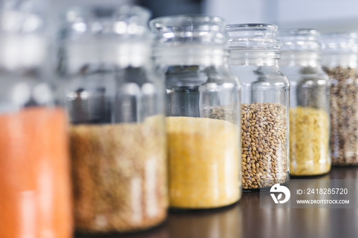 clear pantry jars with different types of grains and legumes including quinoa  lentils buckwheat and