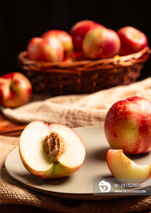 Nectarines in basket and on table.