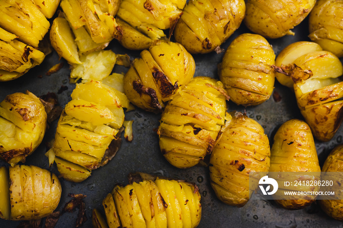 wholesome food ingredients, oven roasted baked potatoes on tray with slices