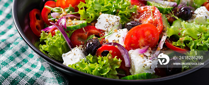 健康食品。希腊沙拉配黄瓜、番茄、甜椒、生菜、红洋葱、羊乳酪和o