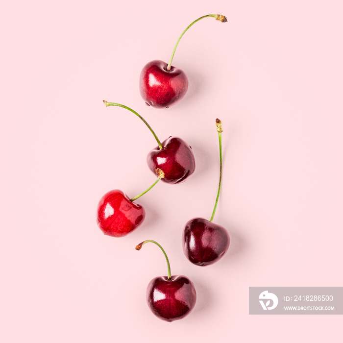 Cherry fruits arrangement on pink background