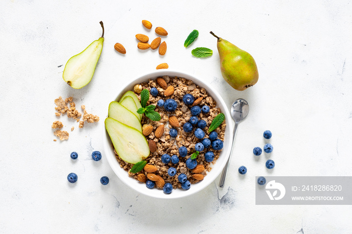 Flat lay healthy breakfast with granola, natural yoghurt, fruits and blueberry berry on white backgr