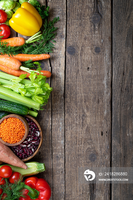 Background healthy food. Fresh vegetables, fruits, beans and lentils on wooden table. Vegetarian foo