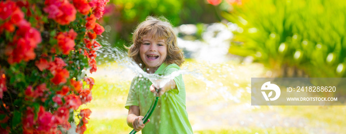 Banner with spring kids portrait. Adorable kid boy watering the plants, from hose spray with water h