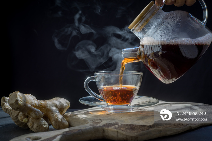 health, traditional medicine and ethnoscience concept.ginger tea on rustic background