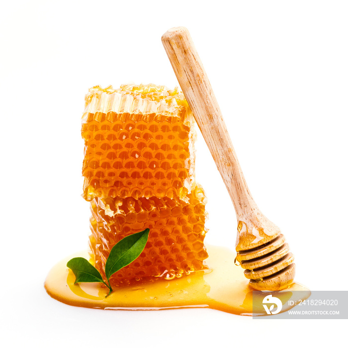 Honeycomb with honey dipper isolated on white background