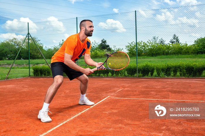 Bearded guy preparing to receive tennis serve