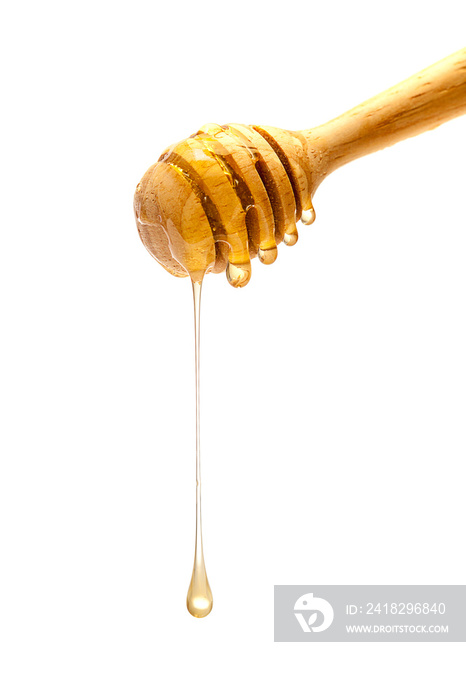Drop of brown honey on a wooden spoon.